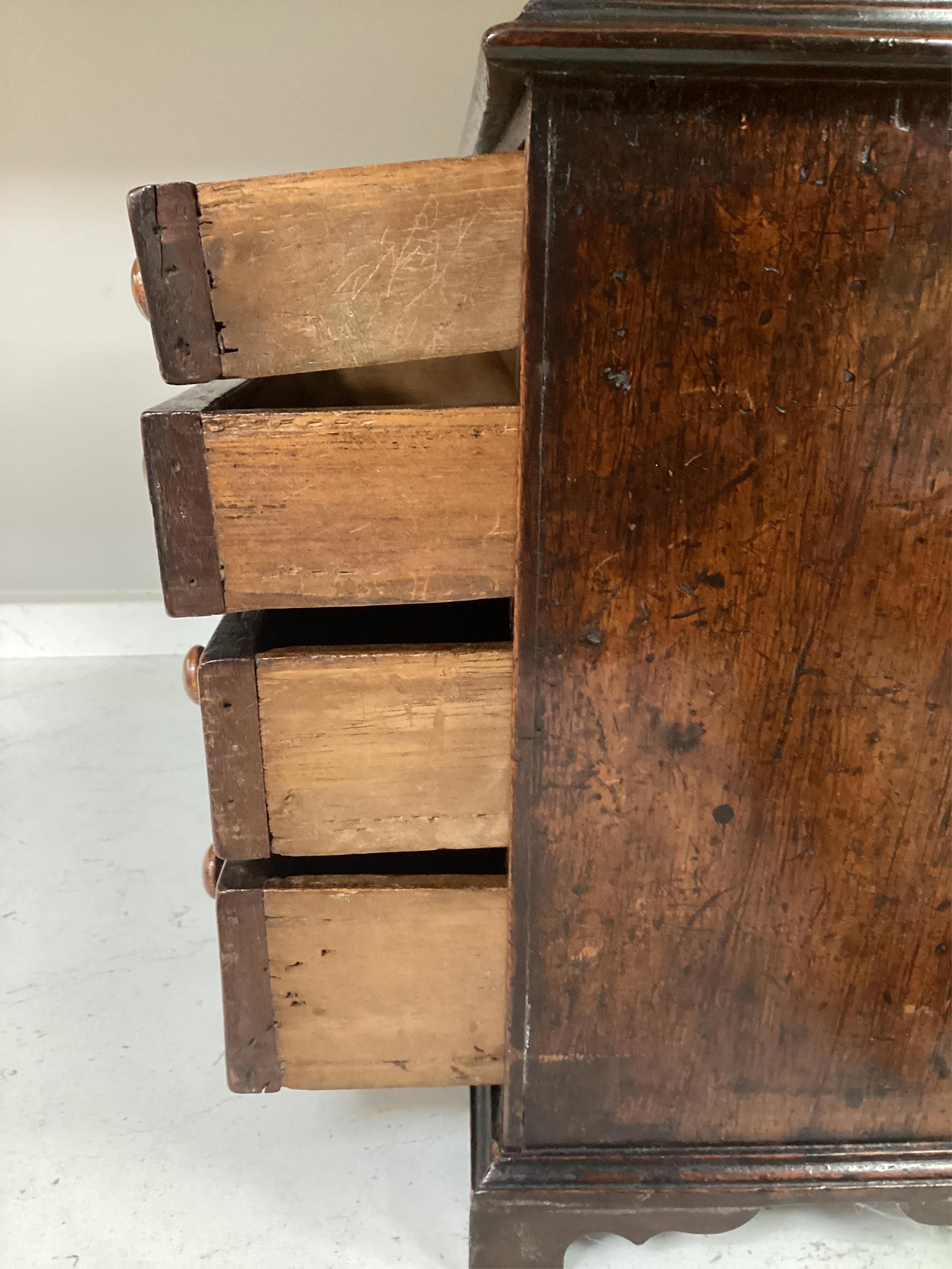 A 19th century miniature mahogany chest of five drawers, 28cm high. Condition - fair to good